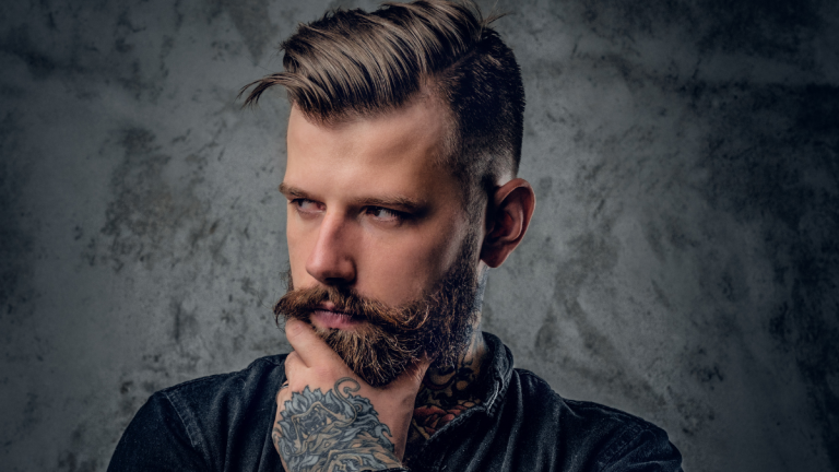 A beard model shows off the beard his barber put together at his barber business of beard shop.