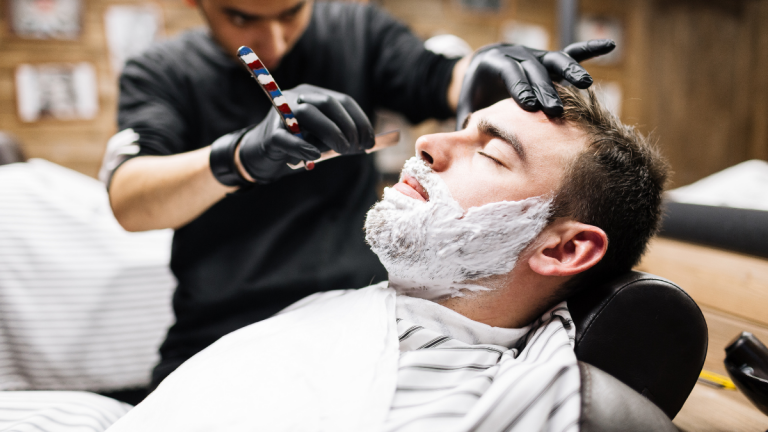A client finishes up his end-of-year barbering appointment.